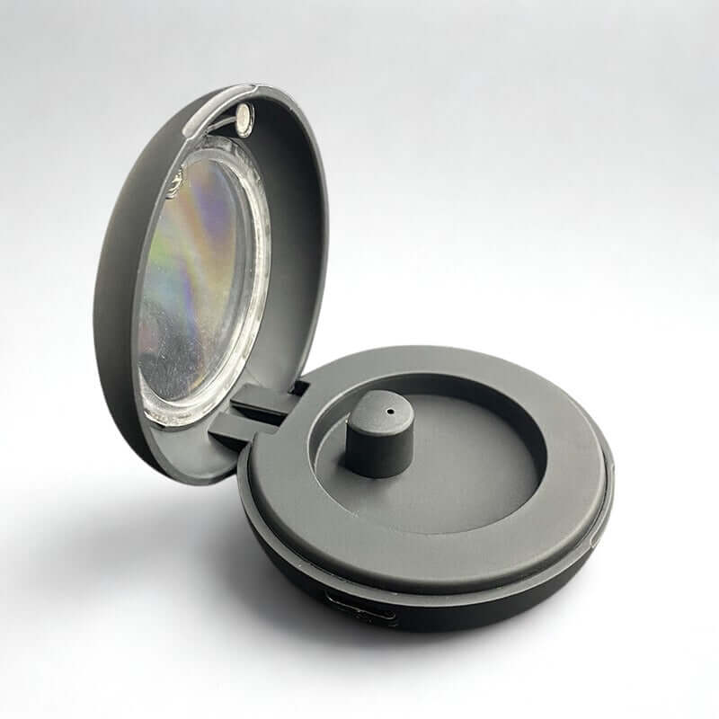 Dixsg Universal Charger for Smart Rings in black with transparent lid and magnetic connection.